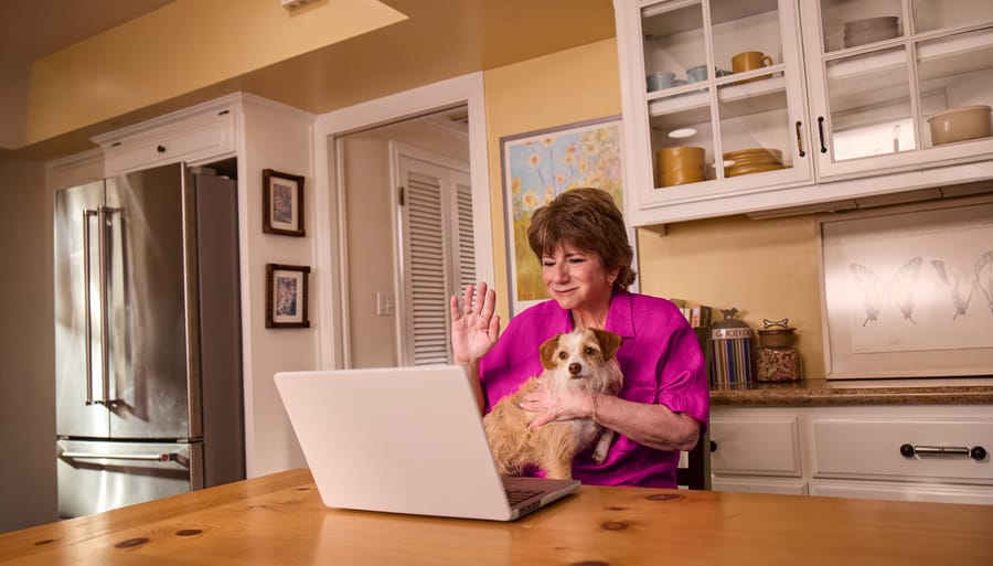 Sheryl, an actual COBENFY (xanomeline and trospium chloride) patient,  on a video call with a COBENFY Champion in her kitchen